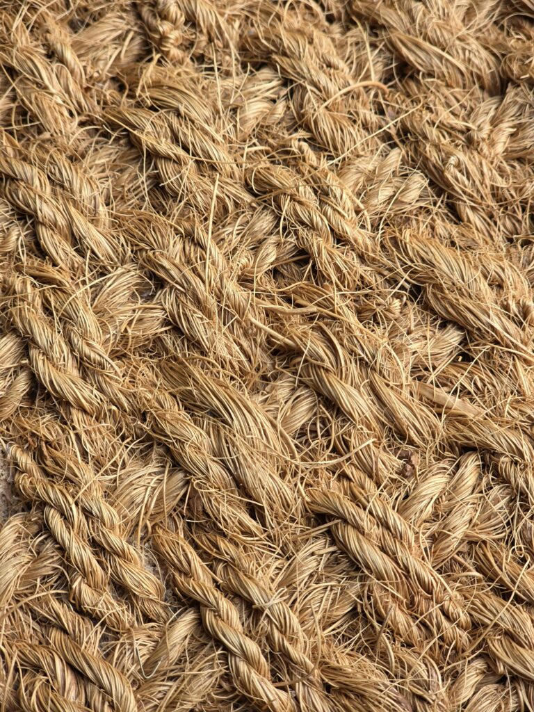 Detailed view of coiled rope texture in natural fibers, showcasing intricate weaving pattern.